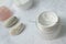 Cream for face, stones on a white cotton towels, spa accessories for skin care, close up