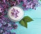 cream moisturizer cosmetic lilac flower plant organic homemade relax aromatic on a blue wooden backgrounextract d