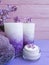 Cream natural cosmetic lilac on wooden harmony, towel, candle
