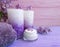 Cream natural cosmetic lilac on wooden, towel, candle