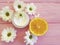 Cream organic cosmetic petal orange handmade bright composition health white flowers on a pink wooden chamomile on blue wooden
