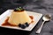 Cream pudding with caramel sauce and blueberries.