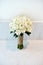 Cream roses wedding bouquet of the bride n the white wall