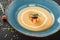 Cream soup of lentils with breadcrumbs on plate on dark grey stone background