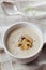 Cream soup with mushrooms champignon and potato in white bowl