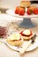 Cream tea, with scones, jam and cream arranged on a table and decorated with fresh strawberries