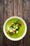 Cream zucchini soup with croutons, Parmesan cheese and fresh dill on wooden table