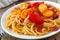 Creamy butternut squash pasta with bacon and cherry tomatoes close-up