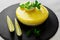 Creamy cheesecake, delicious lemon cheesecake on black rustic plate closeup