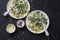 Creamy chicken, green peas, spinach farfalle pasta on a dark background, top view. Mediterranean style