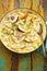 Creamy cider chicken casserole with apples, celery sticks and shallots
