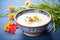 creamy coconut milk soup in a bowl with herbs garnish