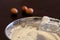 Creamy egg whites on mixer whisks over bowl with brown eggs in background