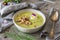 Creamy herbes soup with potatoes, herbes and sorrel, with edible blooms and croutons as topping