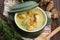 Creamy Jerusalem artichoke soup on wooden background