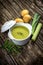 Creamy leek soup on wooden background