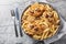 Creamy Marry Me Chicken pasta with sun-dried tomatoes, cheese, herbs and aromatic sauce close-up in a plate. Horizontal top view