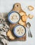 Creamy mushroom soup in bowls with toasted bread, marble background