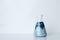 Creamy opaque blue green solution in science glass flask in chemistry laboratory background