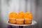 Creamy orange cupcakes on a platter