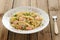 Creamy pasta with salmon and parsley in white plate