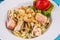 Creamy pasta with shrimps, crab meat, seafood, squid rings, tomatoes, basil, greens and cheese.