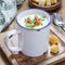 Creamy potato soup garnished with bacon and green onion, square