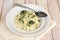 Creamy risotto with broccoli on the cloth and wooden background