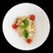 Creamy risotto in porcelain plate isolated on black