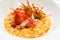 Creamy risotto rice dish with red prawns.