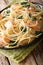 Creamy spaghetti with salmon and spinach close-up on a plate. vertical