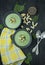 Creamy spinach soup with crackers, herbs and chia seeds. Green soup served in a bowl on a wooden table. Flat lay