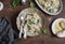 Creamy spinach spaghetti on wooden table, top view.