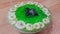 Creamy tasty sweet green jelly with banana slices layered on surface