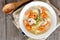 Creamy tortellini and mushroom soup, above scene on rustic wood