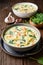 Creamy Tortellini pasta soup with spinach, celery, carrot and chicken broth