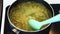 Creamy vegan pesto risotto with green beans cooking in a saucepan handheld camera