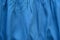 Creased blue cloth material fragment as a background texture