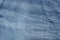 Creased blue denim fabric background texture