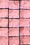 Creased Pink Aluminum foil Squares on black Background