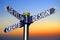 Create, develop, design - signpost with three arrows, sunset sky