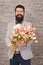 We create emotions. Bearded man with tulip bouquet. Love date. international holiday. Womens day. Flower for March 8