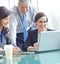 She creates really engaging presentations. A group of executives looking at a business presentation on a laptop while