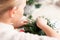Creating Christmas floral arrangement with carnations, chrysanthemum santini flowers and fir