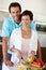 Creating a delicious meal with fresh ingredients. a man standing behind his wife as shes chopping vegetables at the