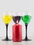 Creating an intimate atmosphere, room decoration: red candle on the background of three glasses filled with hydrogel balls of