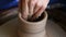 Creating jar or vase of clay. Woman hands, potter`s wheel