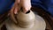 Creating jar or vase of clay. Woman hands, potter`s wheel