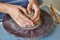 Creating jar or vase of clay. Woman hands, potter`s wheel