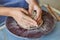 Creating jar or vase of clay. Woman hands, potter`s wheel